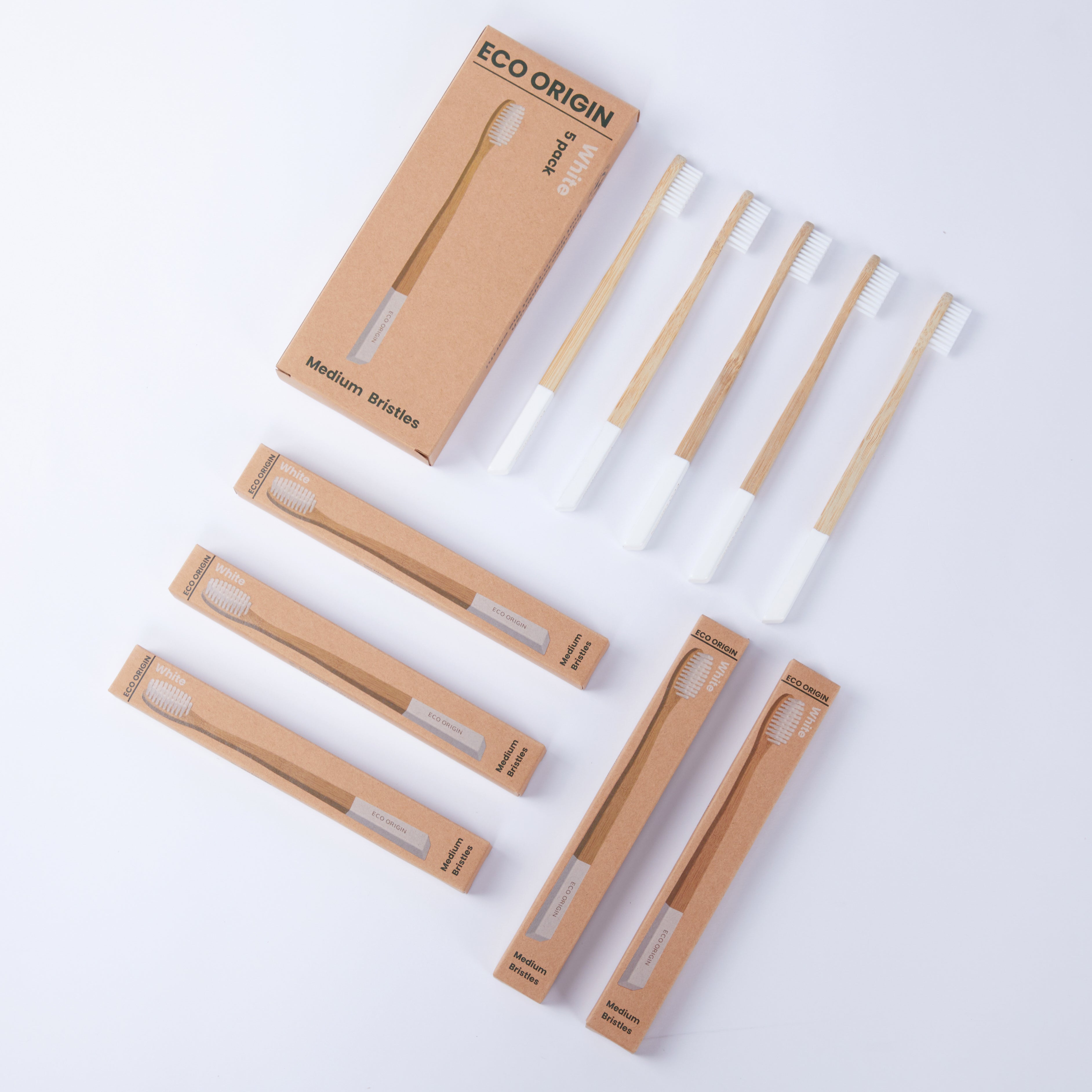 Eco Origin bamboo toothbrush 5-pack with white medium bristles displayed in eco-friendly packaging. Eco Origin bamboo toothbrush 5-pack with white medium bristles displayed in eco-friendly packaging.