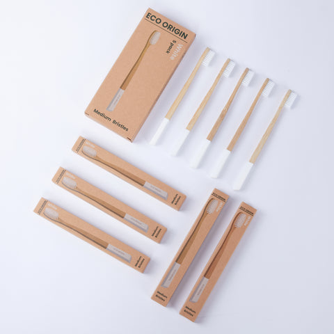Eco Origin bamboo toothbrush 5-pack with white medium bristles displayed in eco-friendly packaging. Eco Origin bamboo toothbrush 5-pack with white medium bristles displayed in eco-friendly packaging.